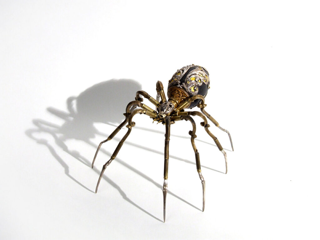 Spider sculpture by Jessica Joslin. "Uttu", Antique hardware and findings, painted wood, brass, silver, steel, 5" x 8" x 8"