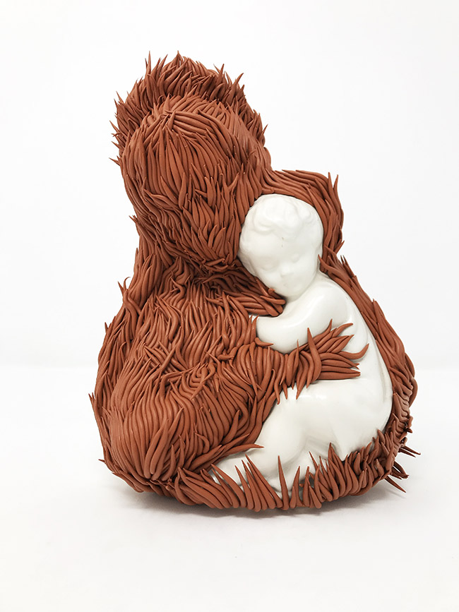 Sculpture by Andrèa Keys Connell. "Feathers Fall, Grass Grows", Found ceramic figurine, polymer clay, 12" x 8" 6"